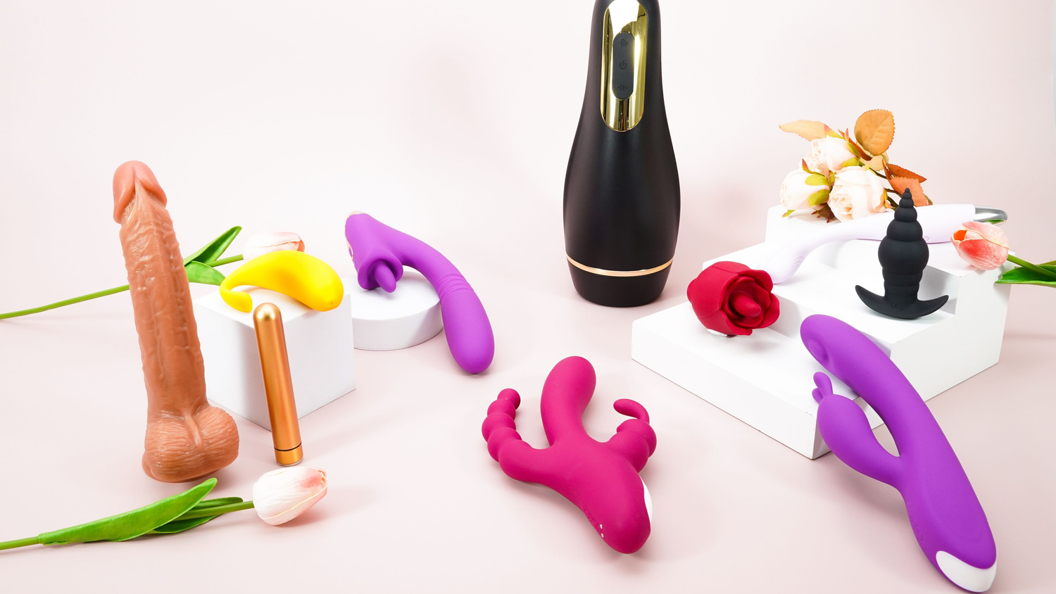 A variety of colorful female sex toys are placed on the table