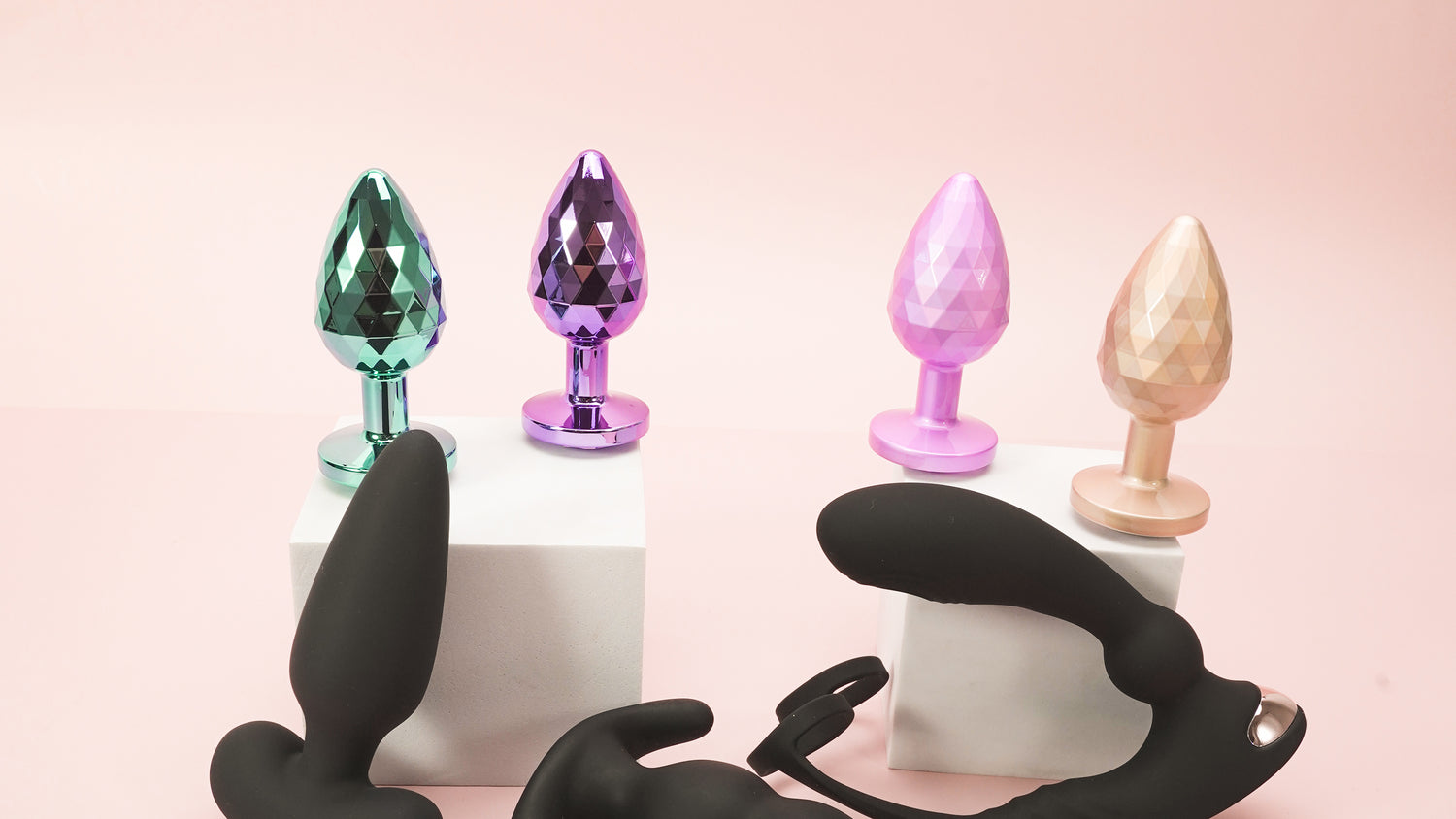 Various colorful sex toys displayed on pedestals.